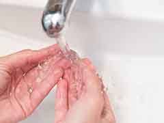 Patient rinsing their aligners in sink