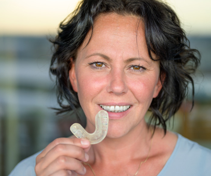 Woman holding a nightguard in Torrance