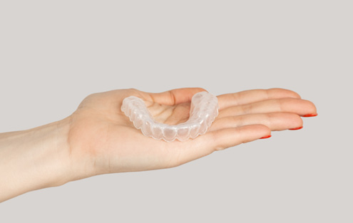 Close-up of hand holding a nightguard