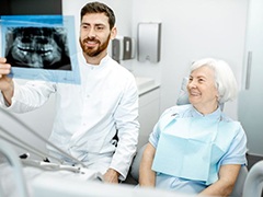 Dentist and patient reviewing X-ray together