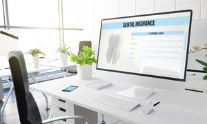 Dental insurance form on a large computer monitor